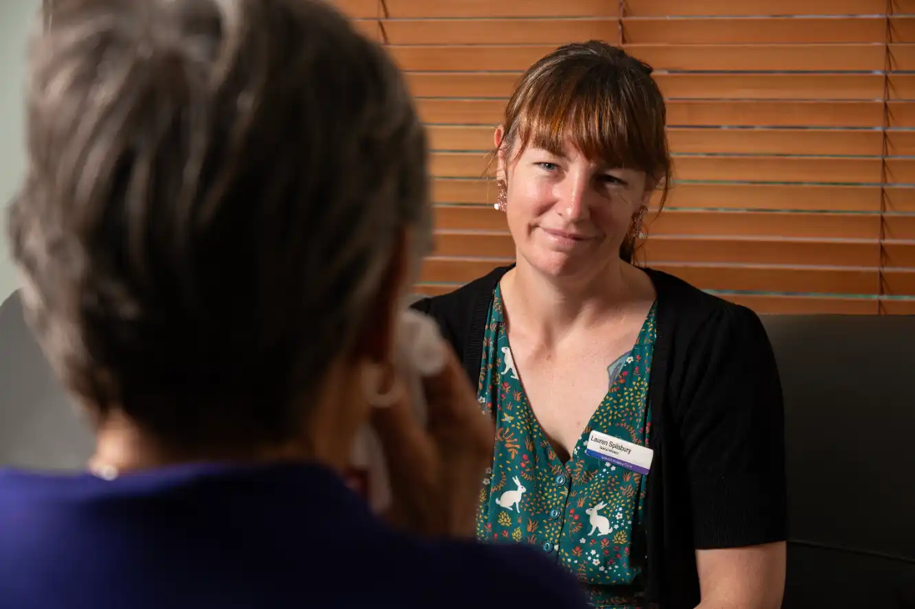 Nurse talking with older female patient.